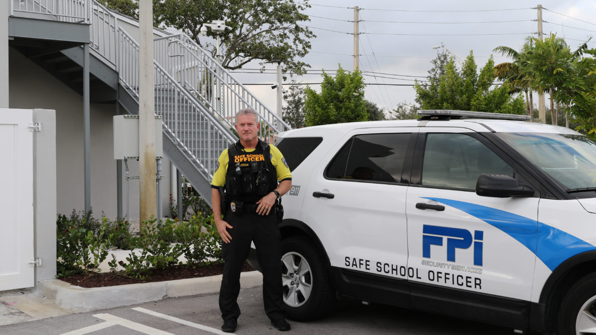FPI School safety officers stands outside his car in front of FPI headquarters.
