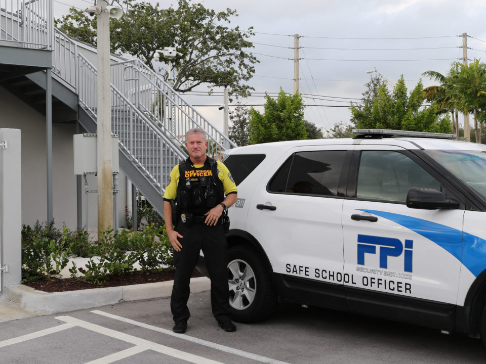 FPI School safety officers stands outside his car in front of FPI headquarters.