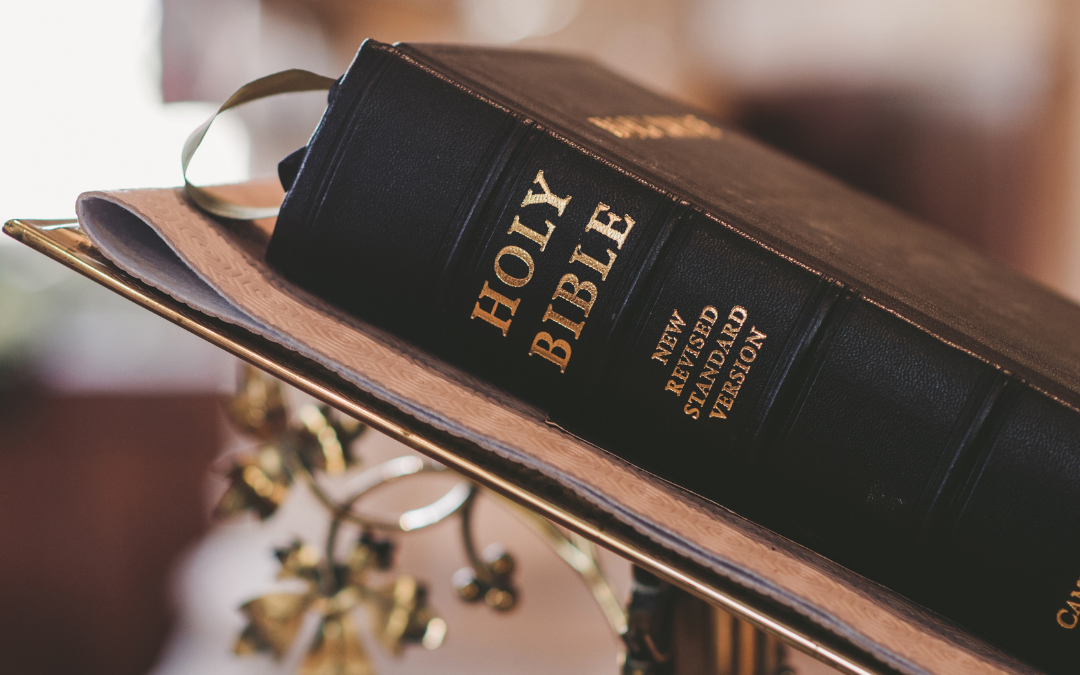 This is a picture of a bible on a table inside of a church.
