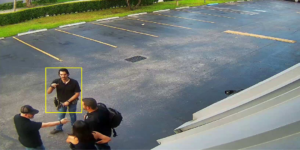 This is an image of 3 men wearing black shirts and jeans talking in the parking lot of Florida gun center located in hialeah florida.